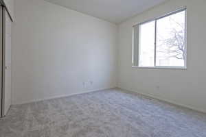 Empty room featuring light colored carpet