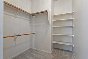 Spacious closet featuring carpet flooring