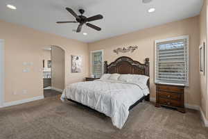 Bedroom featuring ceiling fan and carpet floors