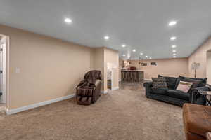 Carpeted living room featuring indoor bar