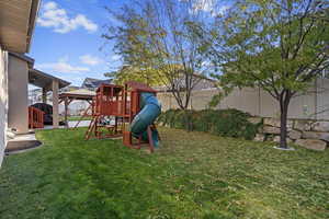 View of play area with a lawn