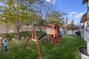 View of playground featuring a lawn