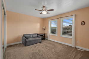 Sitting room with carpet floors and ceiling fan