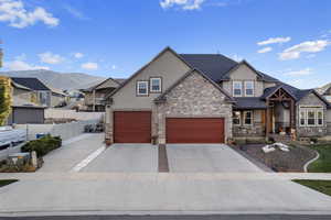 View of front of home featuring a mountain view and a garage