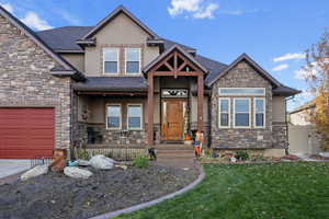 View of front of property with a front yard and a garage