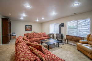 Carpeted family room with a wood stove