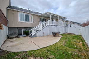 Rear view of property with a patio and a lawn