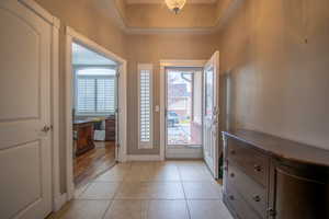 Tiled foyer featuring plenty of natural light