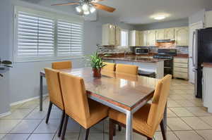 Tiled dining space with ceiling fan