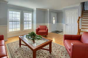 Living room featuring crown molding and wood-type flooring