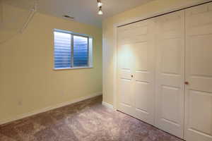 Unfurnished bedroom with carpet floors and a closet