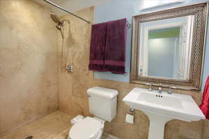 Bathroom with tiled shower and toilet