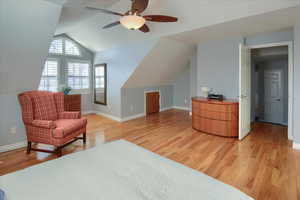 Sitting room featuring hardwood / wood-style floors, ceiling fan, and lofted ceiling