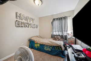 Bedroom featuring carpet flooring and a textured ceiling