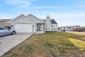 View of front facade with a garage and a front lawn