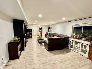 ADU / Basement Living room with light hardwood / wood-style flooring