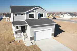 View of front of property featuring a garage and a porch