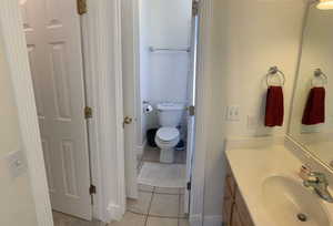 Bathroom with tile patterned floors, vanity, and toilet