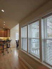 Dining space with light hardwood / wood-style floors and lofted ceiling