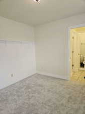 Unfurnished room with light colored carpet