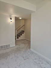 Unfurnished room featuring light colored carpet