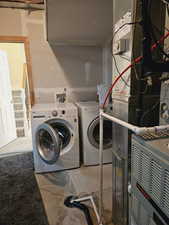 Clothes washing area with washer and dryer and heating unit