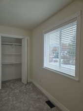 Unfurnished bedroom with carpet flooring and a closet