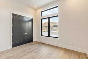 Interior space with a mountain view and light hardwood / wood-style flooring