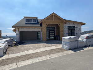 Property under construction featuring a shingled roof and a garage