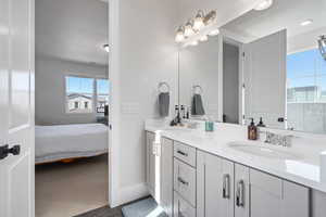 Bathroom with a textured ceiling, vanity, and tile patterned floors