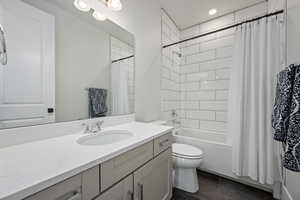 Full bathroom featuring vanity, toilet, and shower / tub combo