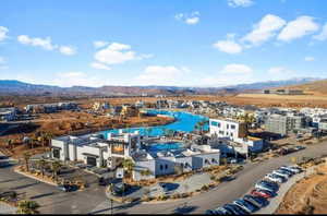 Birds eye view of property with a water and mountain view