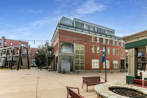 View of building exterior with an outdoor fire pit