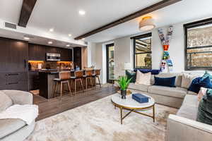 Living room featuring beamed ceiling and hardwood / wood-style flooring