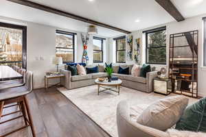 Living room featuring beamed ceiling and hardwood / wood-style floors