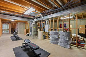 Basement featuring heating unit and water heater