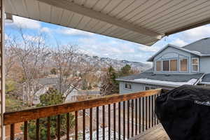 Wooden terrace featuring a grill and a mountain view