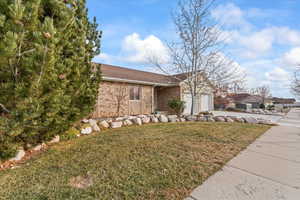 View of front facade with a front lawn and a garage