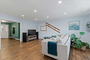 Living room with dark hardwood / wood-style flooring