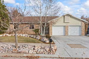 Ranch-style home featuring a garage and a front yard