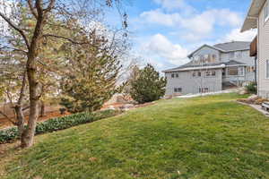 View of yard with a balcony