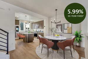 Dining area with a chandelier, light wood finished floors, stairway, and recessed lighting