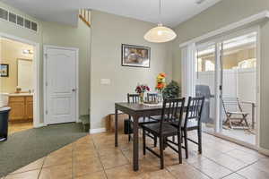 Tiled dining area featuring sink