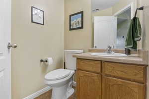 Bathroom featuring tile patterned flooring, vanity, and toilet