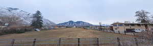 View of yard with a mountain view, a rural view, and a garage