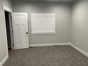 Empty room with dark carpet