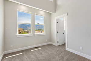 Carpeted empty room featuring a mountain view