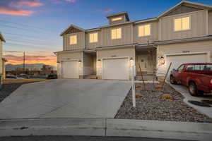 View of front facade featuring a mountain view and a garage