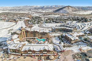 Snowy aerial view featuring a mountain view