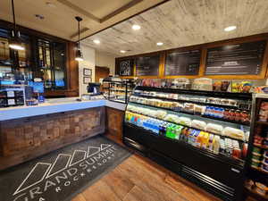 Bar featuring pendant lighting, wooden ceiling, and hardwood / wood-style floors